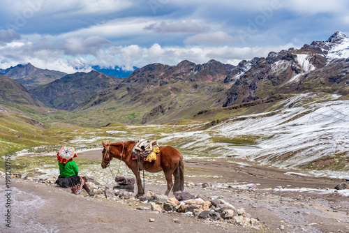 Wallpaper Mural Local peruvian woman in traditional clothes resting next to a horse with the breathtaking glacial scenery of the Vilcanota mountain range in the background Torontodigital.ca