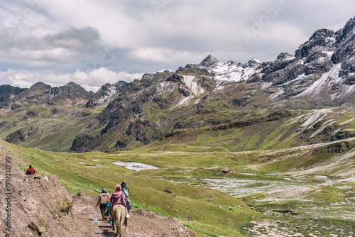 Wallpaper Mural Tourist riding a horse on the path to Rainbow Mountain, surrounded by the scenic landscape of the Peruvian Andes Torontodigital.ca