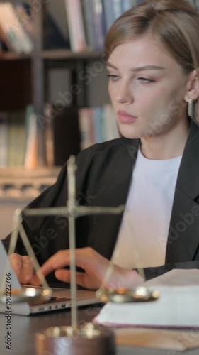 Wallpaper Mural Female Lawyer Working on Legal Documents and Laptop, Vertical Video Torontodigital.ca