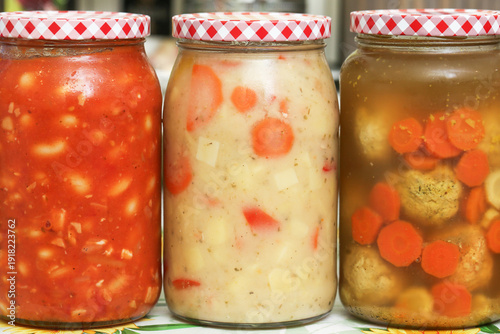 фотографія Homemade soups preserved in glass jars