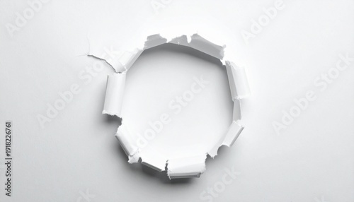 A jagged circular tear bursts through a white surface.