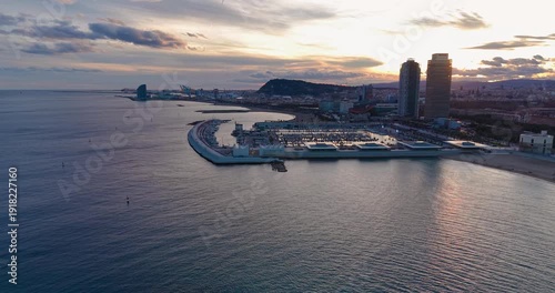 Barcelona city lights panorama at sunset over Mediterranean sea