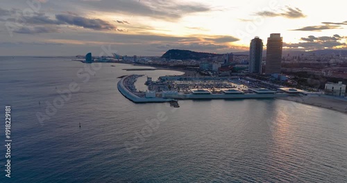 Barcelona city lights panorama at sunset over Mediterranean sea