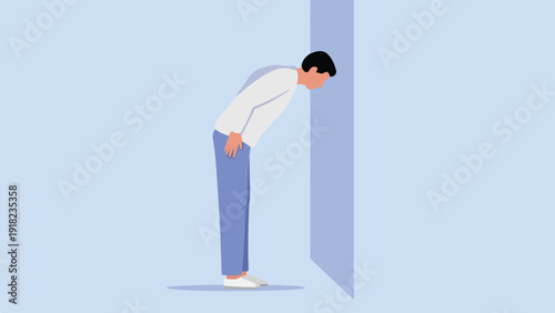 A person in casual clothes leans their head against a wall