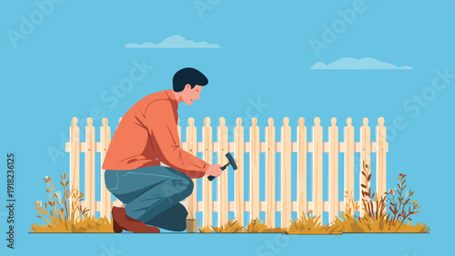 Man kneels and hammers fence post surrounded by dry grass against blue sky