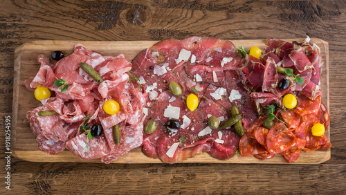 Obraz na plátně A cured meat platter of salami, chorizo, beef, ham with pickles, gherkins and pa