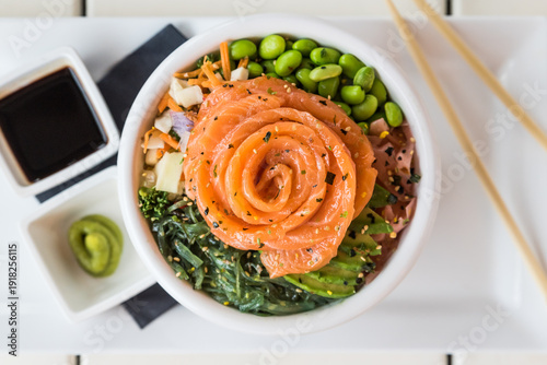 A smoked salmon poke bowl with mixed raw vegetables