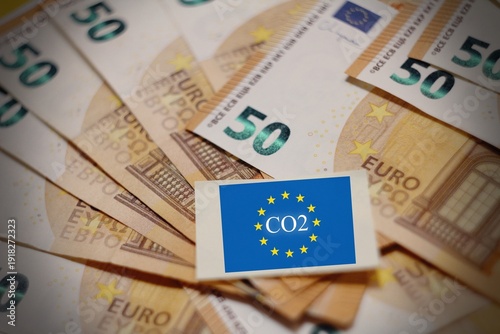 Illustration of the EU carbon tax concept with euro banknotes overlayed on the European Union flag. Symbolizes the financial impact of CO2 emissions, environmental policies,