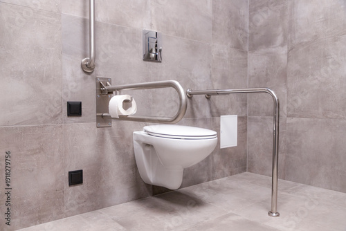 Fotografija Modern toilet in the bathroom adapted for people with disabilities with grab bar