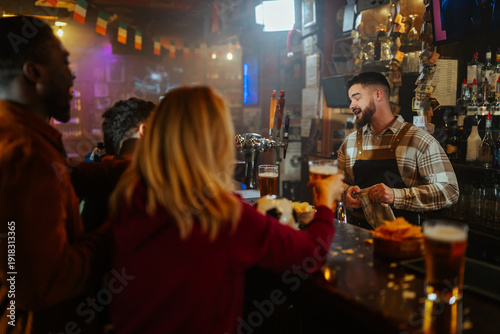 Bilde på lerret Bartender serving beer to people at pub