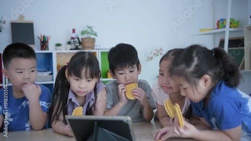 Wallpaper Mural Educational concept of 4k Resolution. Asian kindergarten children eat snacks and look at tablets in playroom in kindergarten. Torontodigital.ca