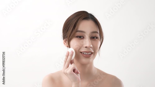 Wallpaper Mural Beauty concept of 4k Resolution. Asian woman is using a makeup sponge to touch her cheeks on a white background. Torontodigital.ca