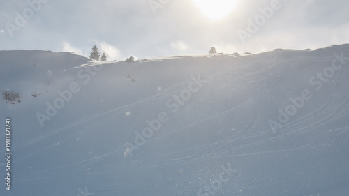 Minimalist snow covered alpine slope in soft winter light, Stoos Switzerland