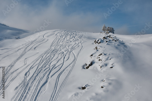 Snow covered alpine ridge with ski trails, Stoos Switzerland