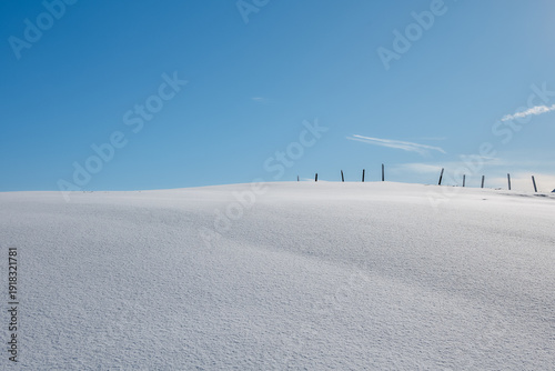 Minimal snowy alpine ridge under clear blue sky, Stoos
