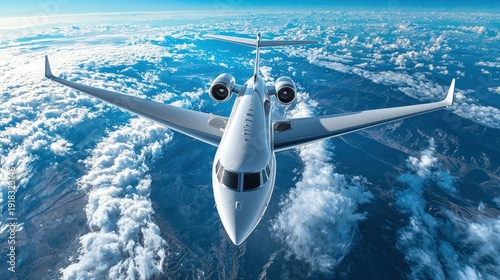 Private jet flying above clouds and mountains.  Possible stock photo use showcasing luxury travel