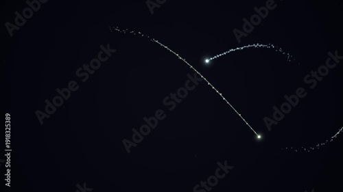 Two bright meteors streak across the dark night sky, leaving glowing trails behind them, a celestial spectacle.