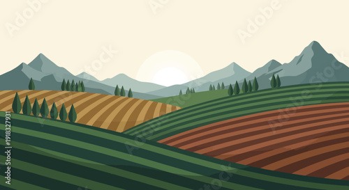 Pastoral valley landscape with layered fields and distant mountain range at sunset.