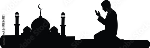 Silhouette of a Muslim Man Praying in Front of a Mosque