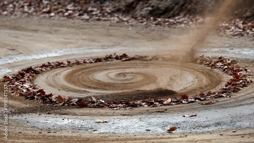 Wallpaper Mural Earth swirls upwards as leaves encircle a sandy spiral on a dirt path in late autumn Torontodigital.ca