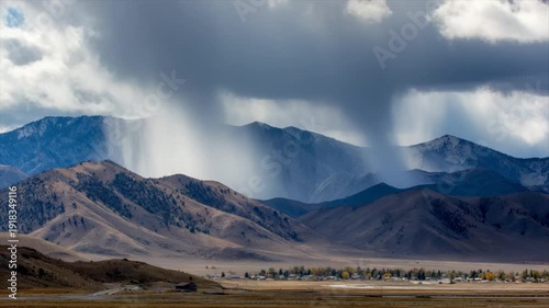 Wallpaper Mural A mountainous landscape with rain falling from a cloud, over a town Torontodigital.ca