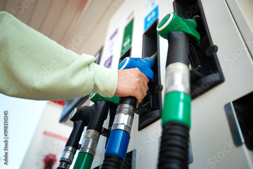 Man holding pump ready to refuel car with gasoline