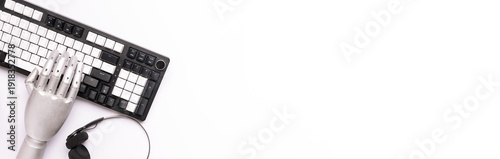 Artificial intelligence concept. Metal robotic hand working with lap top keyboard on white background top view. Copy space for your design. New technologies in bussines and education.