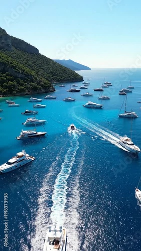 Aerial view of luxury yachts and boats navigating clear blue waters near