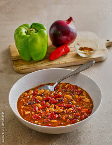 three bean chili made with green bell pepper, red onion, and spicy chilies
