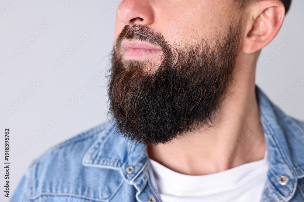 Fototapeta premium Man with mustache and beard on light grey background, closeup
