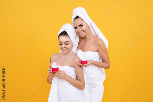 Beauty cream for mom and daughter. Facial skin portrait of mother and daughter. Natural glow and healthy skin. Facial cosmetics family. Beautiful skin for mother. Family care and beauty. Skin cream.