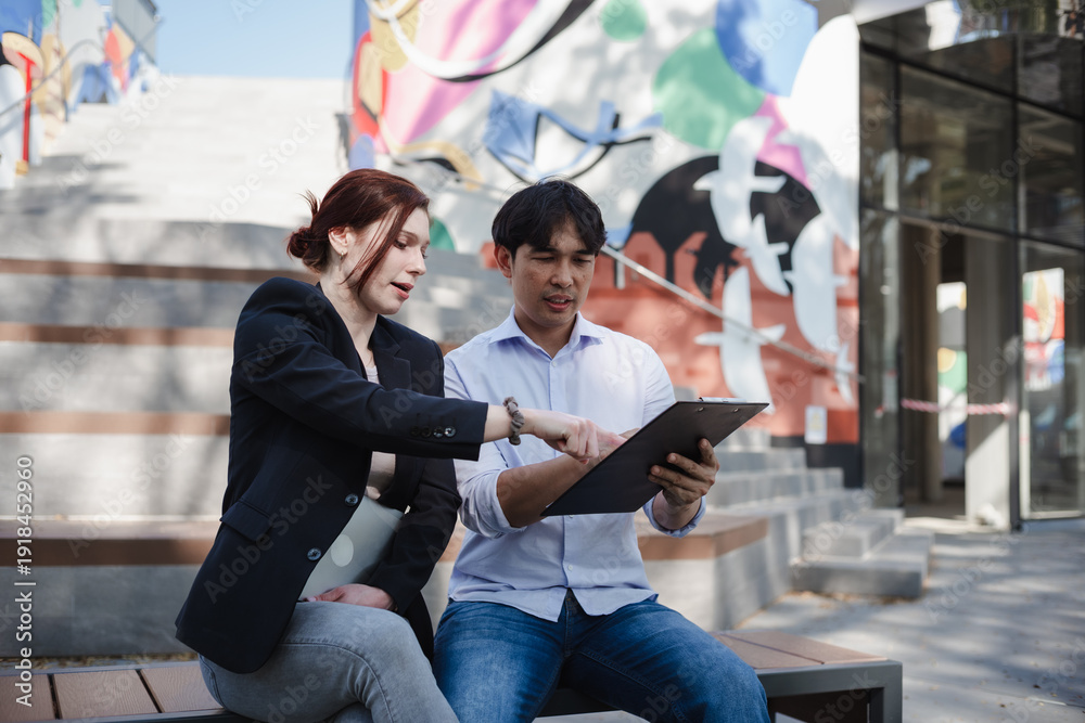 Fototapeta premium Business partners discussing strategy outdoors on a bench