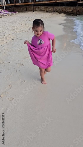 little girl walking and dancing by the sea