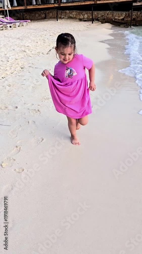 little girl walking and dancing by the sea