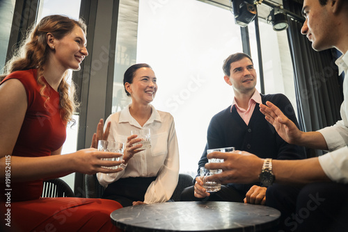 Photography Group of diverse professional people having a friendly meeting and drinking at a bar