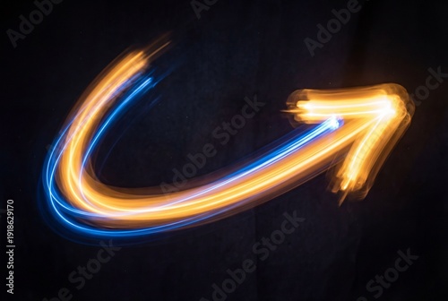 Abstract glowing light trail arrow in amber and blue against a dark background