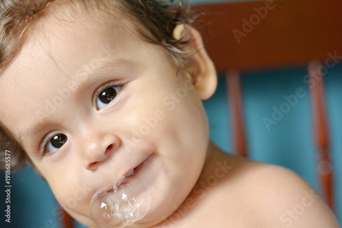 Latin toddler with saliva bubbles.