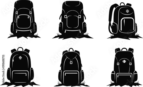 Black backpacks with white outlines on grass hiking