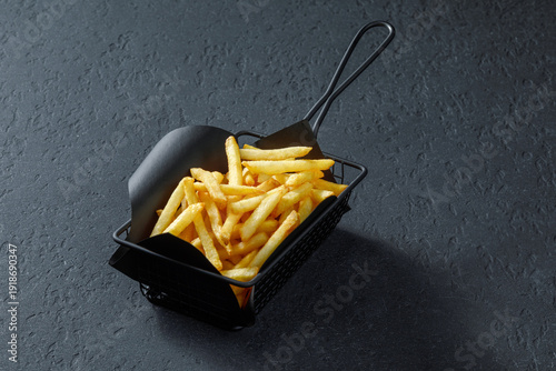Golden french fries in metal basket