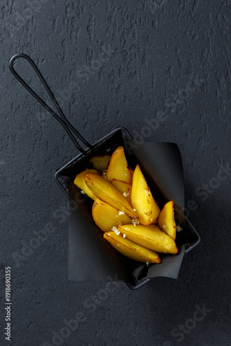 Roasted potato wedges in serving basket