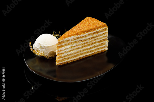 Layered honey cake slice with ice cream