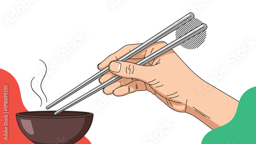 Close up of a hand holding a pair of metal chopsticks over a steaming brown bowl of food on a white background.
