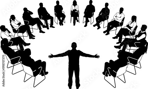Silhouette of a male leader addressing a diverse group of people sitting in a circle for a corporate workshop.