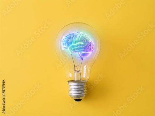 Creative mind concept featuring a glowing brain inside a light bulb on a yellow background