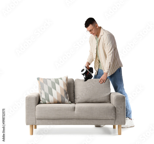 Young man vacuum cleaning g...