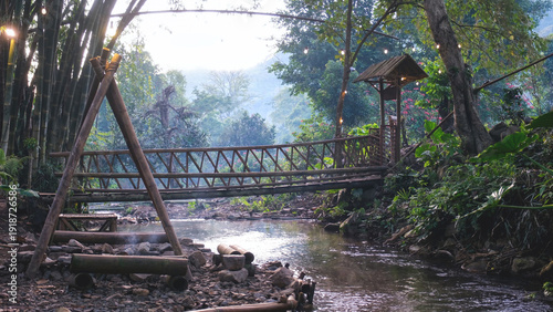 Bild auf Leinwand A canal flowing down under wooden bridge in the forest
