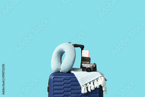Obraz na plátně Suitcase, travel pillow, photo camera, passport and ticket on color background