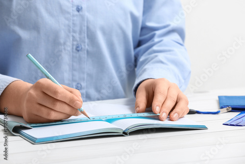 Young woman with ruler, pen...