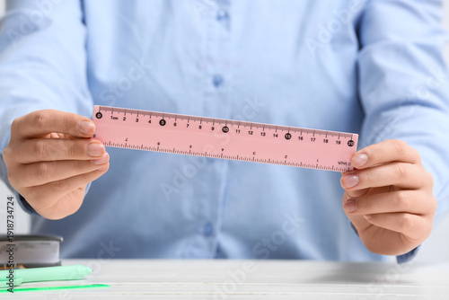 Young woman with ruler at t...
