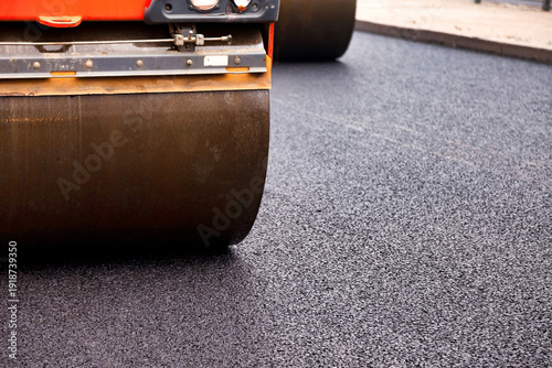 Photos Construction workers are laying asphalt concrete on an urban street